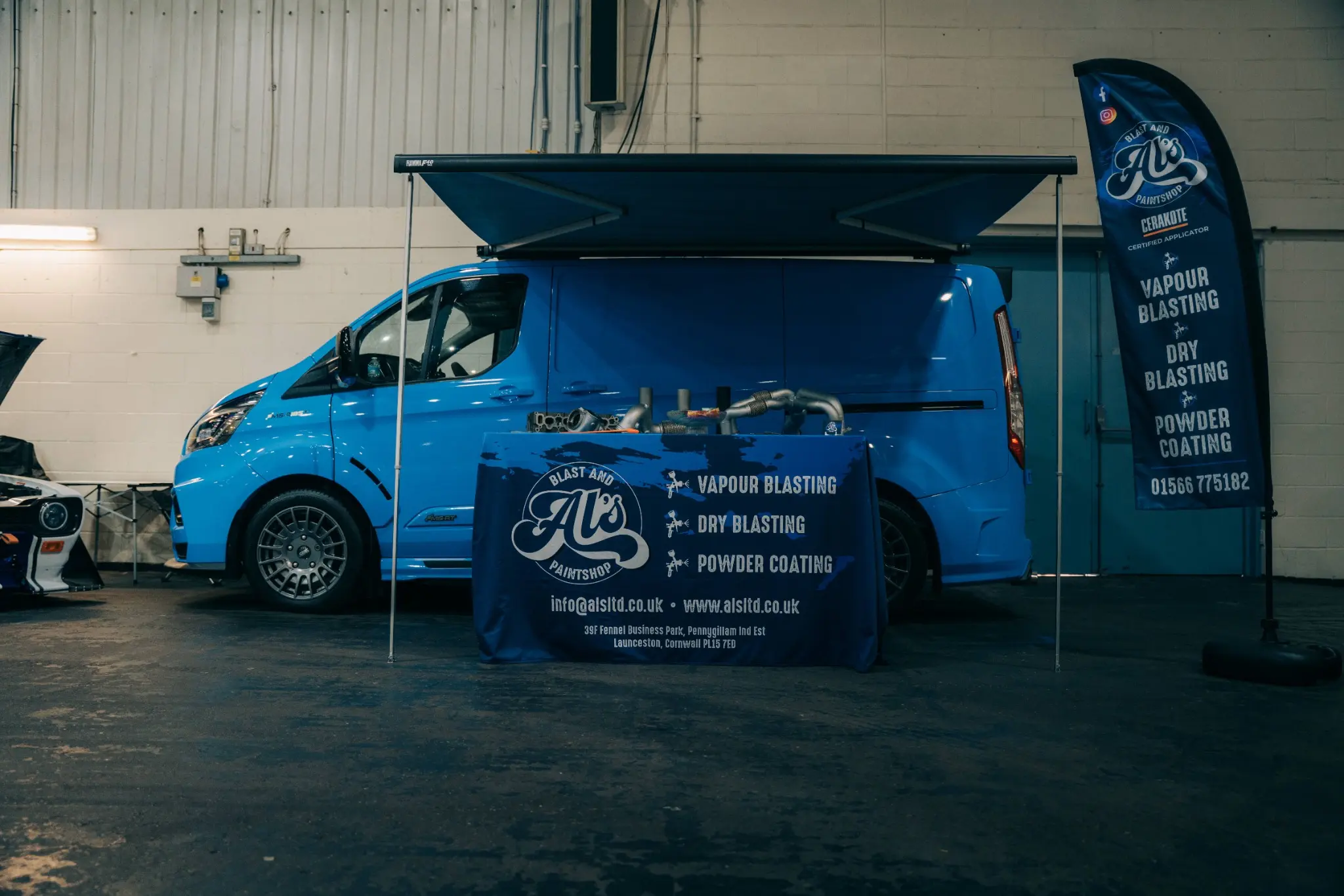 AL's Blast and Paintshop display and branded van at an industry event